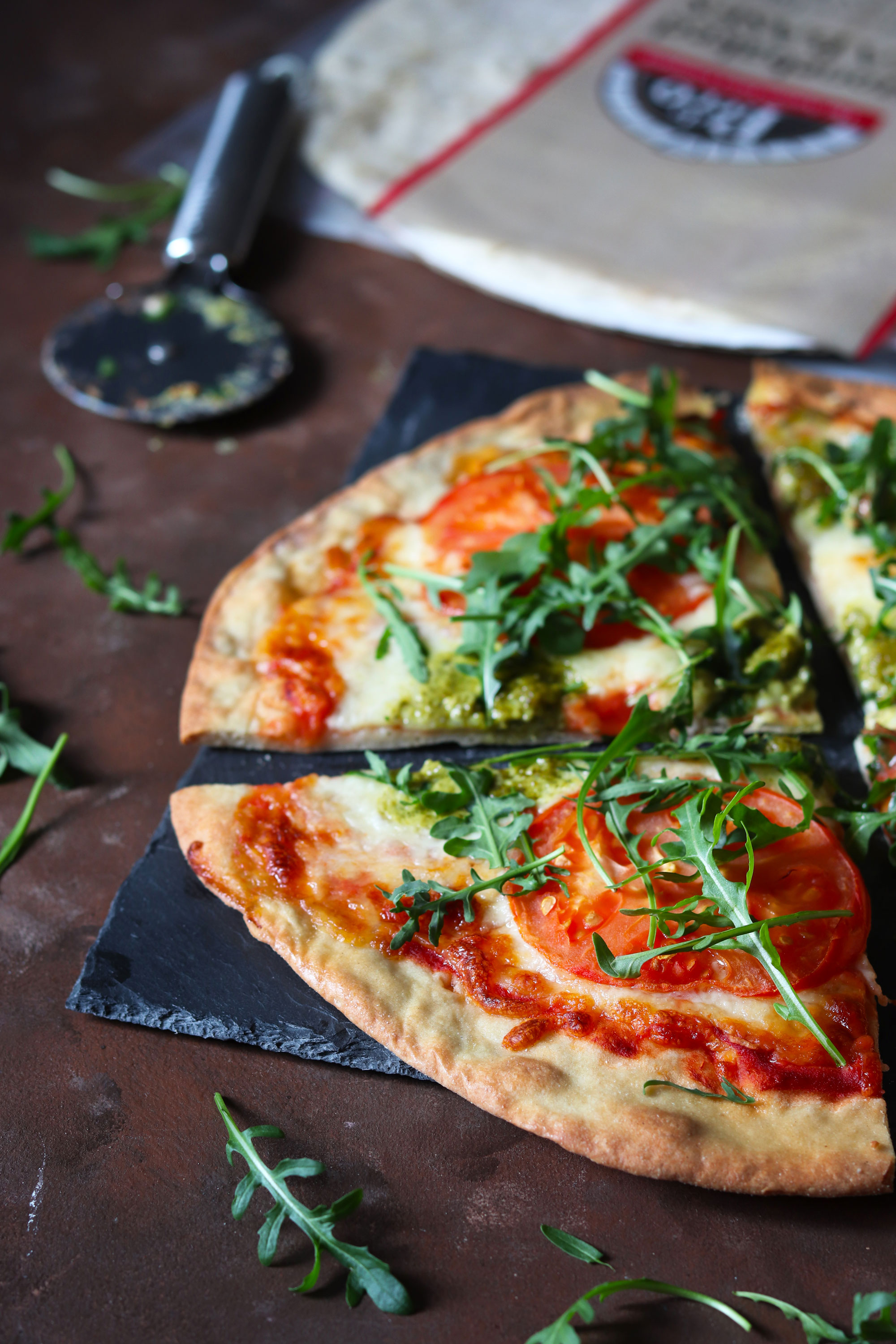 tomato mozzarella and basil pesto pizza